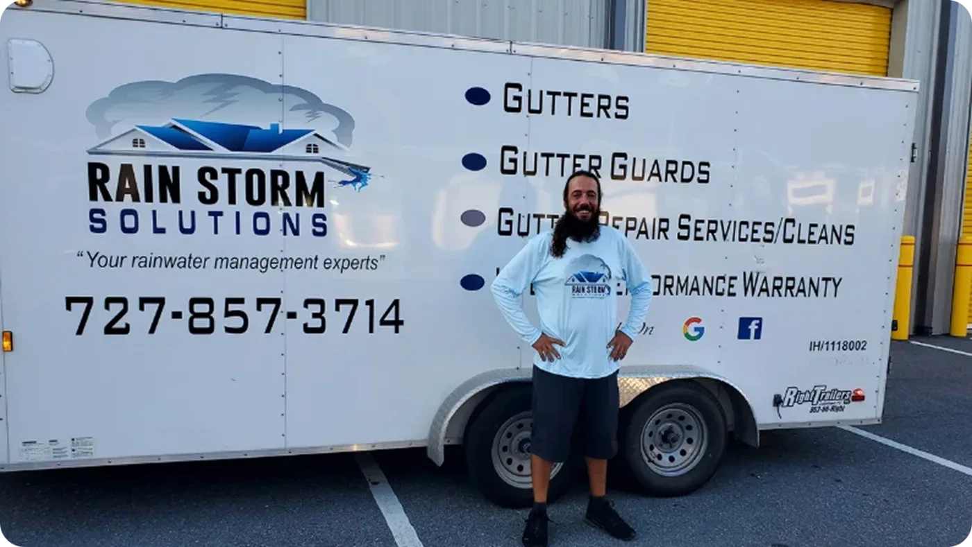The Rain Storm Solutions branded truck and trailer parked at a job site with the crew