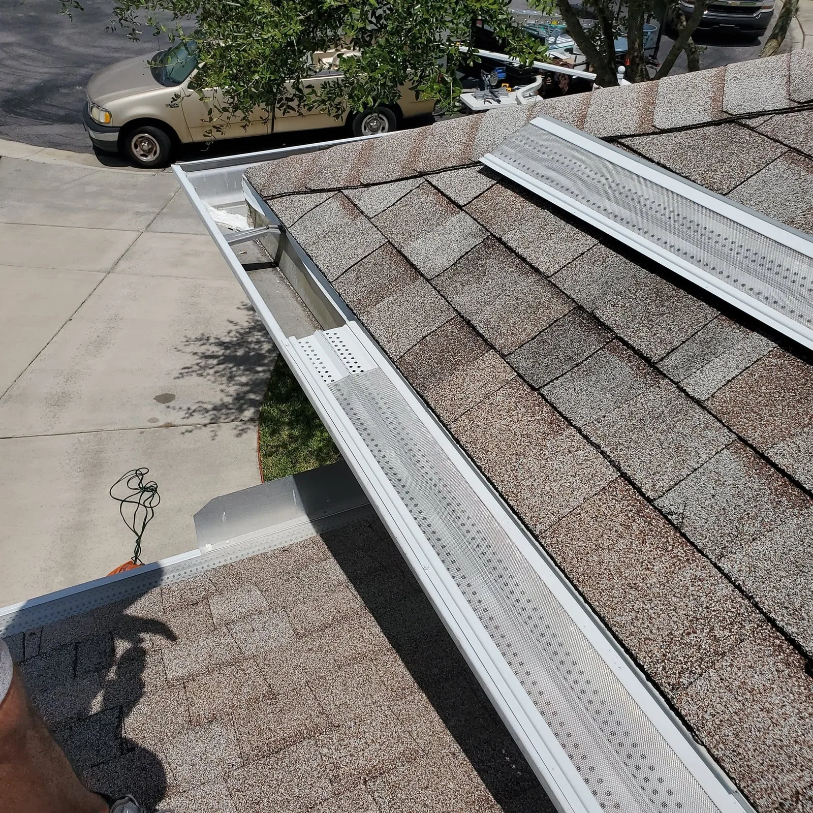 A white seamless gutter installed straight along a home's roofline