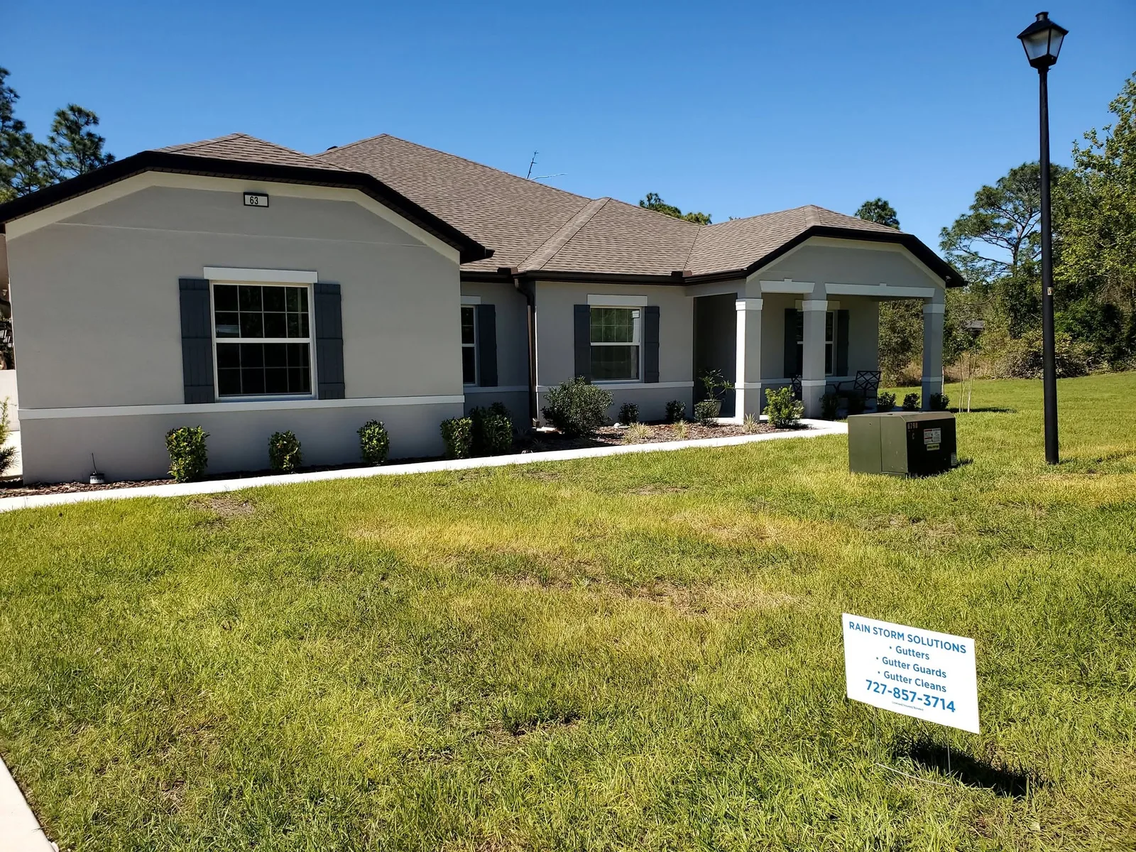 A single-story home with newly installed seamless gutters