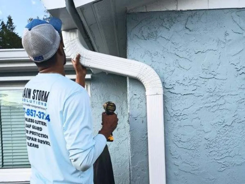 Gutter technician inspecting home to provide a gutter installation cost estimate