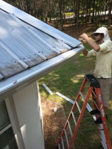 Installing gutters on metal a roof in Florida