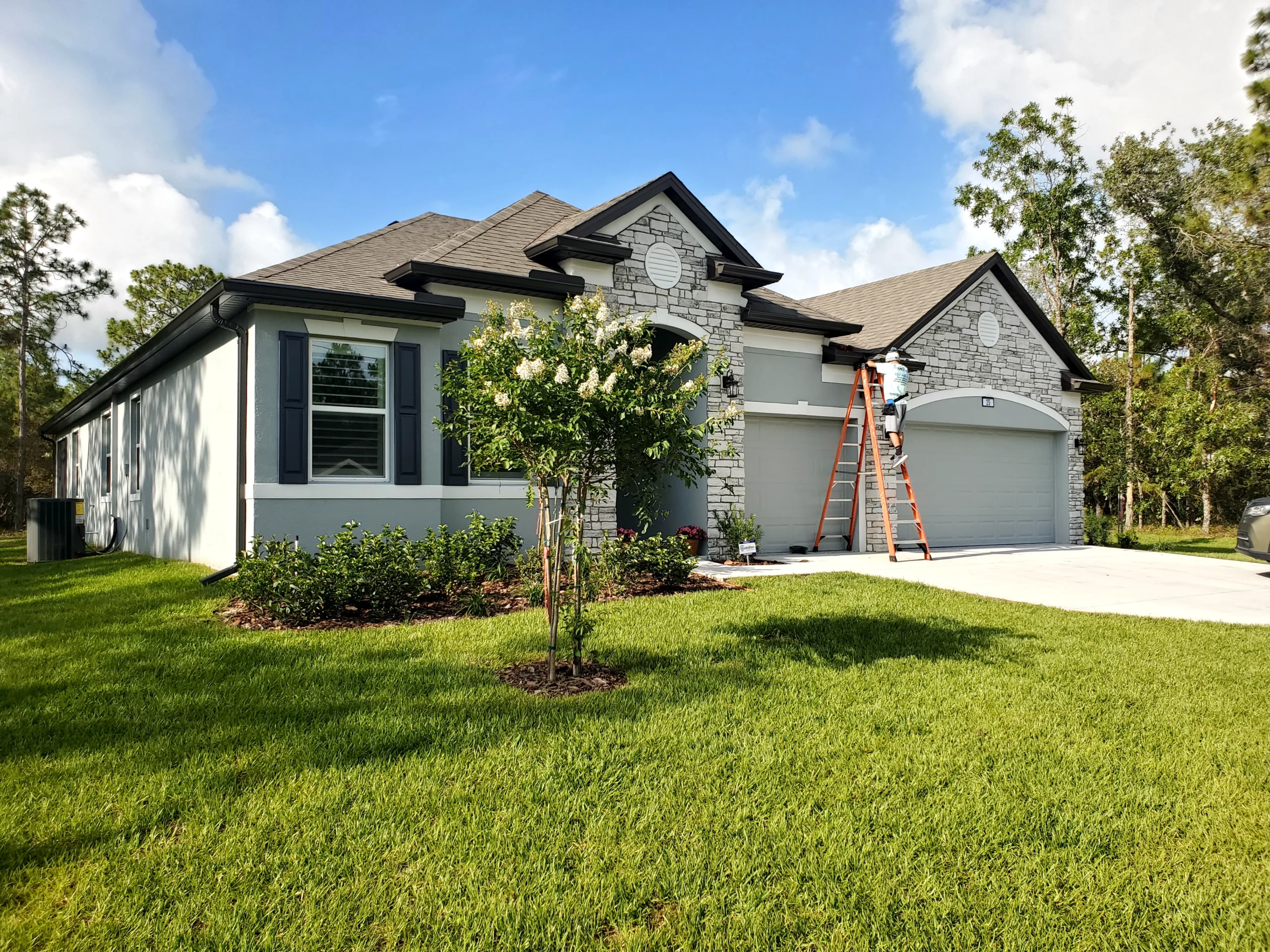 Rain Storm Solutions technician installing gutters on a home in Florida.